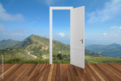 Landscape behind the opening door photo