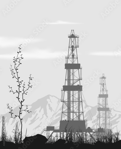 Oil rigs over mountain range.