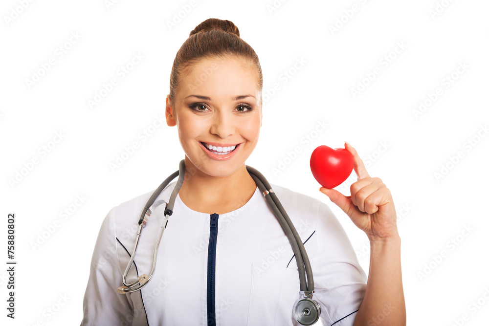 Female doctor holding heart model Female doctor holding heart model