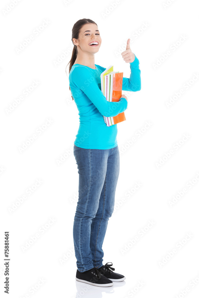 Full length woman holding notes showing thumbs up Full length woman holding notes showing thumbs up