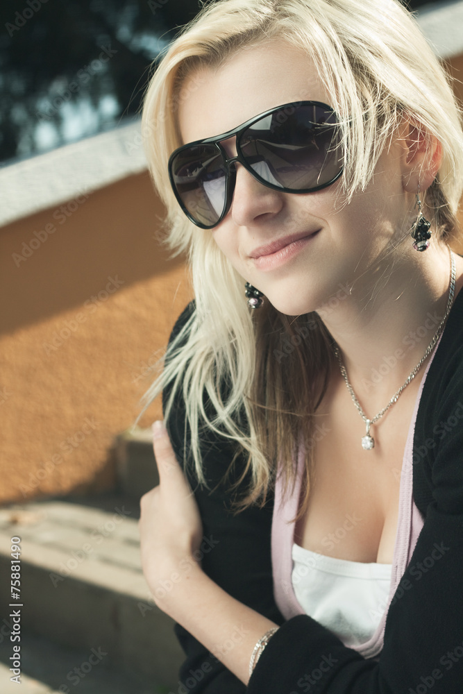 girl in sunglasses sitting on stairs girl in sunglasses sitting on stairs