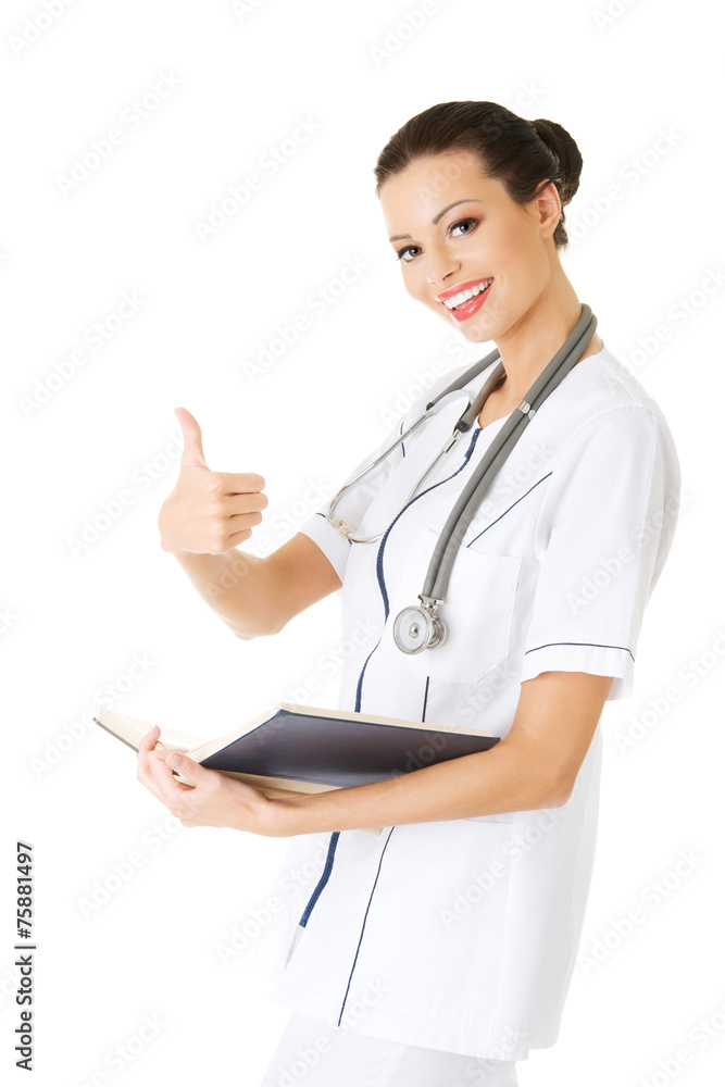 Female doctor with thumb up gesture and notes Female doctor with thumb up gesture and notes