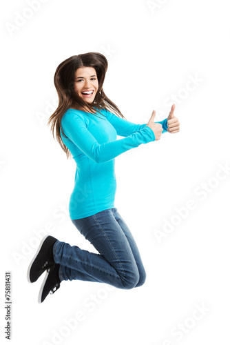Side view happy woman jumping with thumbs up