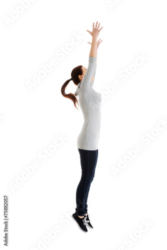 Side view woman trying to catch something high