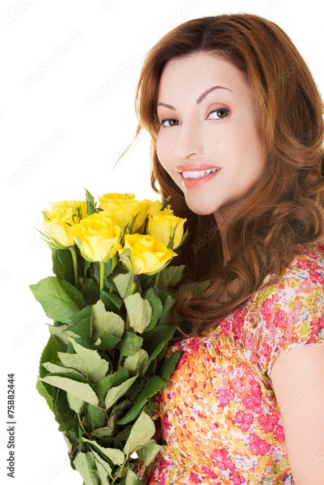 Side view happy woman holding bunch of roses Side view happy woman holding bunch of roses
