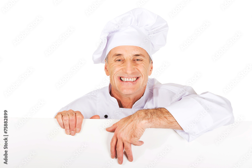 Chef in white uniform holding empty banner Chef in white uniform holding empty banner