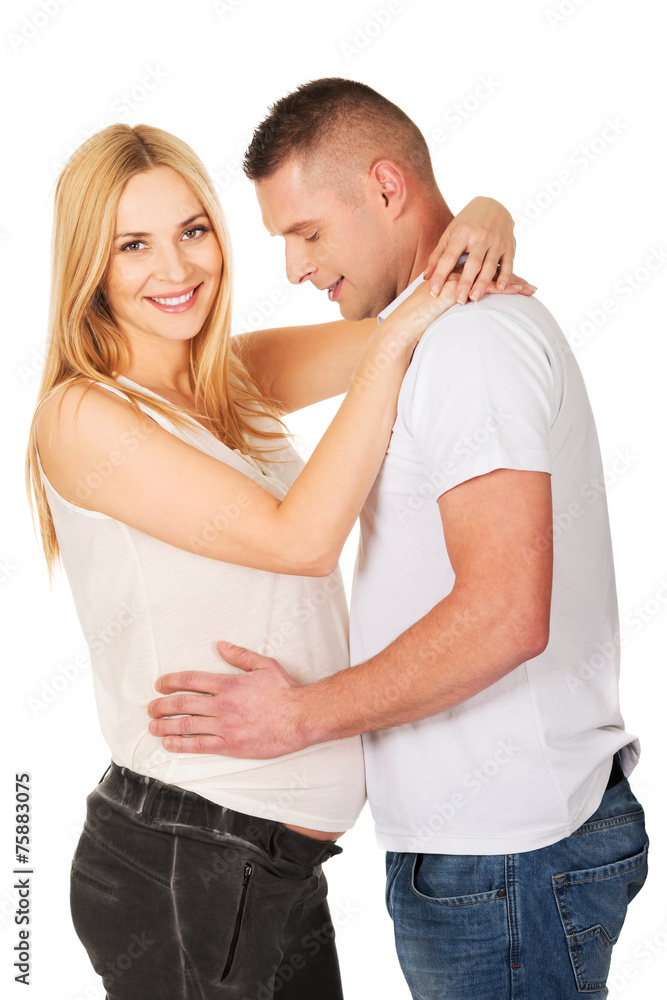 Young man touching his wife pregnancy belly Young man touching his wife pregnancy belly