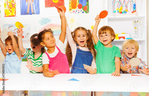Happy kids showing cardboard shapes