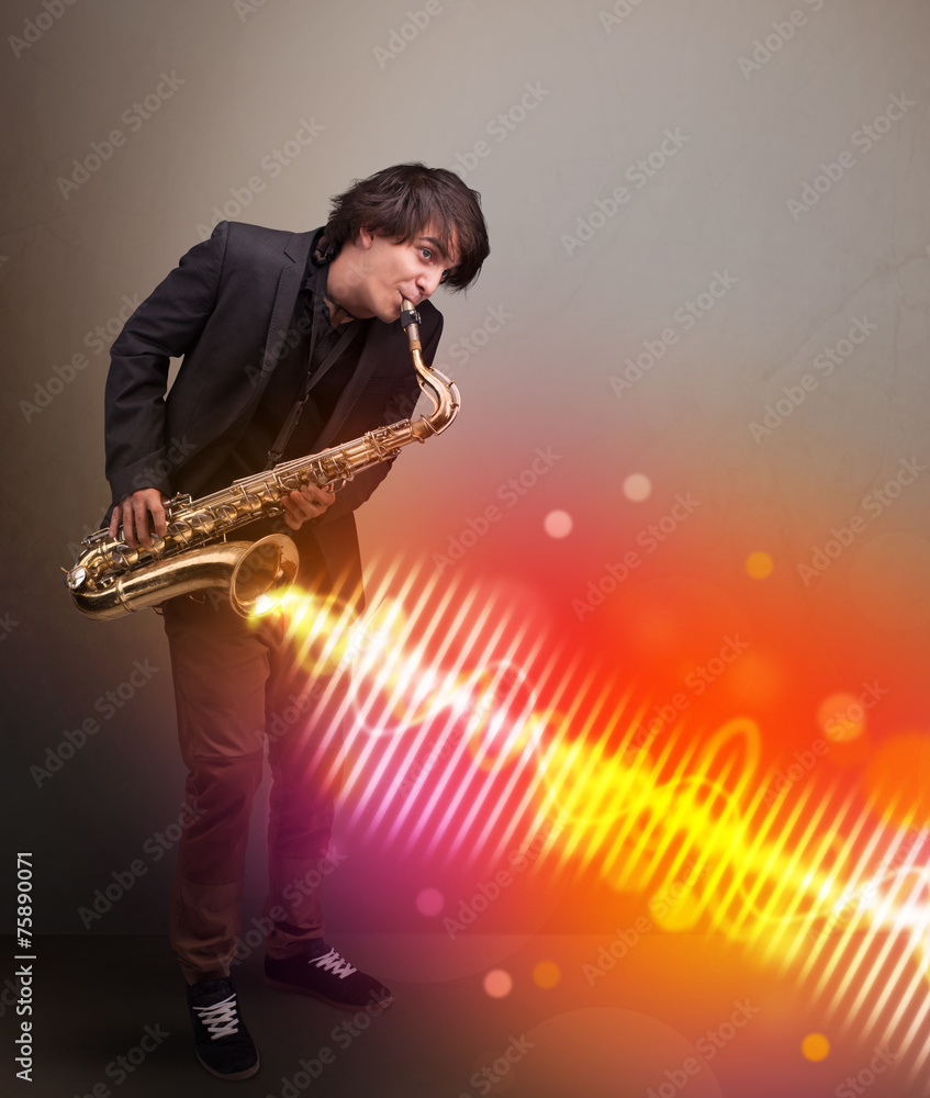 Naklejka premium Young man playing on saxophone with colorful sound waves