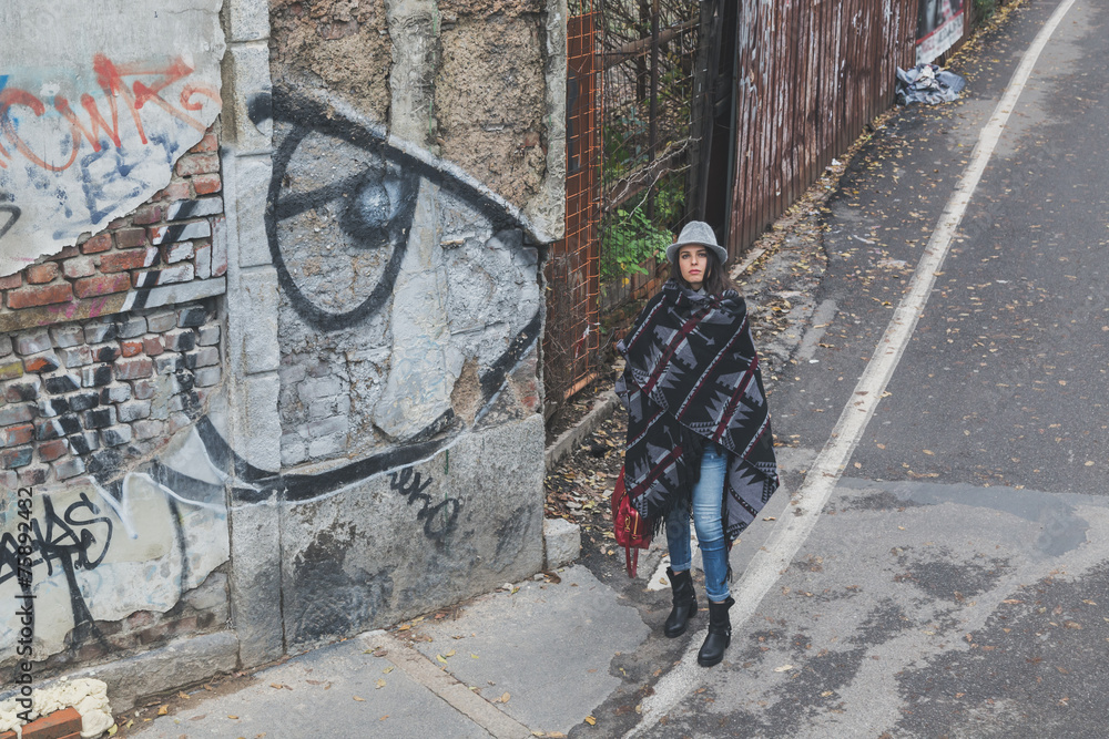 Naklejka premium Beautiful young brunette posing in the city streets
