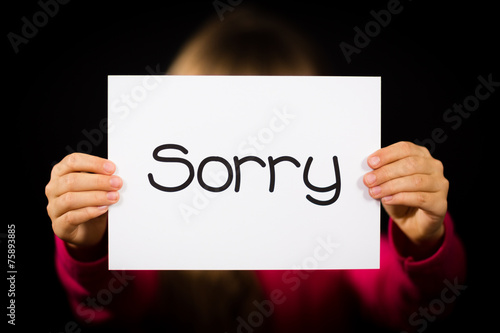 Child holding Sorry sign