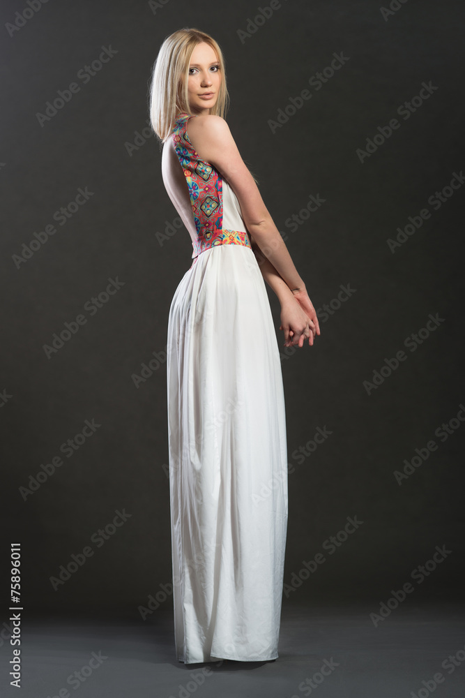Full-lenght photo of lnonde woman in white long dress Full-lenght photo of lnonde woman in white long dress