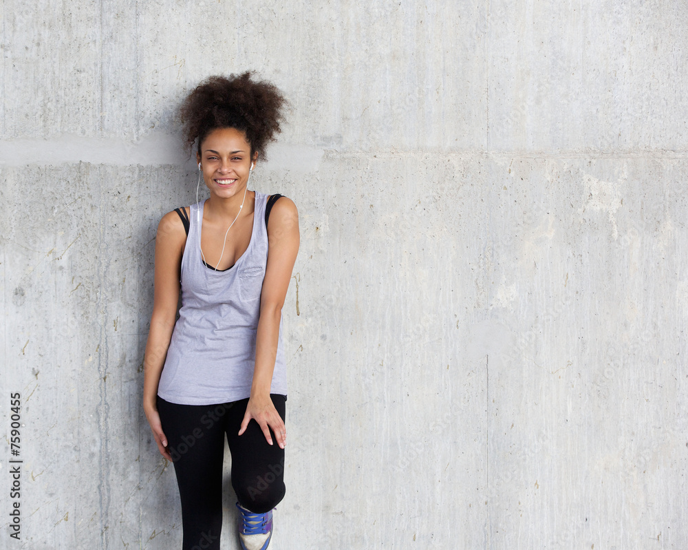 Fototapeta premium Cute young sports woman smiling with earphones