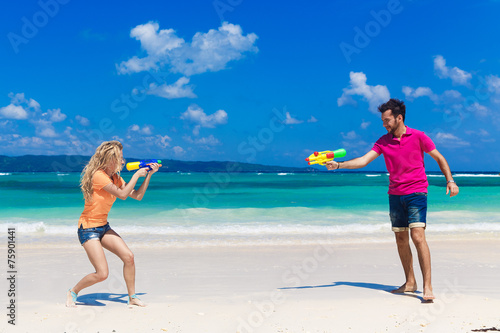 young loving couple having fun on a tropical beach