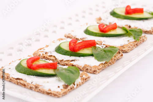 Cracker with fresh vegetables and cream