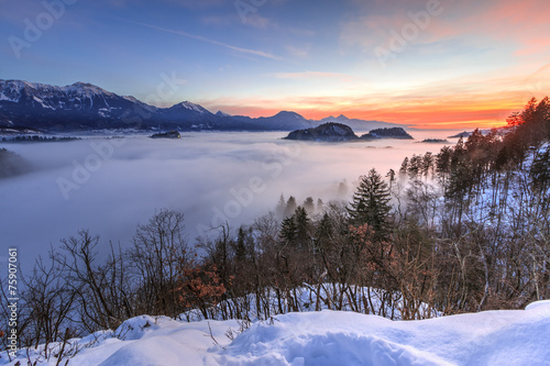 View over the fog covered bled lake to the alps at dawn