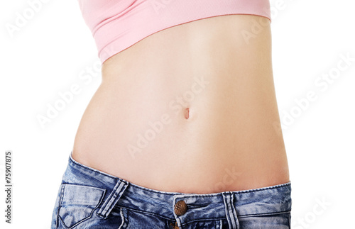 Closeup on fitness woman showing flat belly