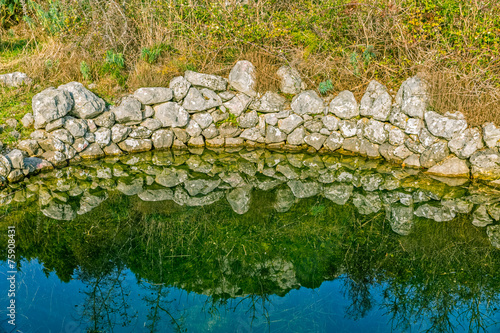 Ancient water trough in the field photo