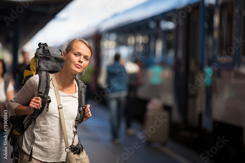 Pretty young woman boarding a train/having arrived