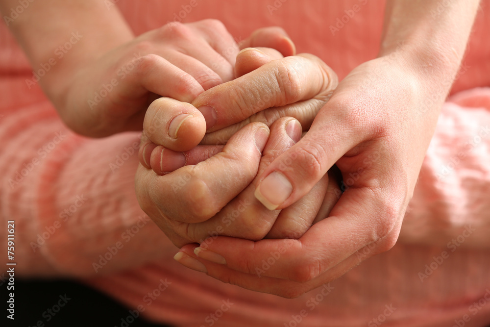 Old and young holding hands, closeup Old and young holding hands, closeup
