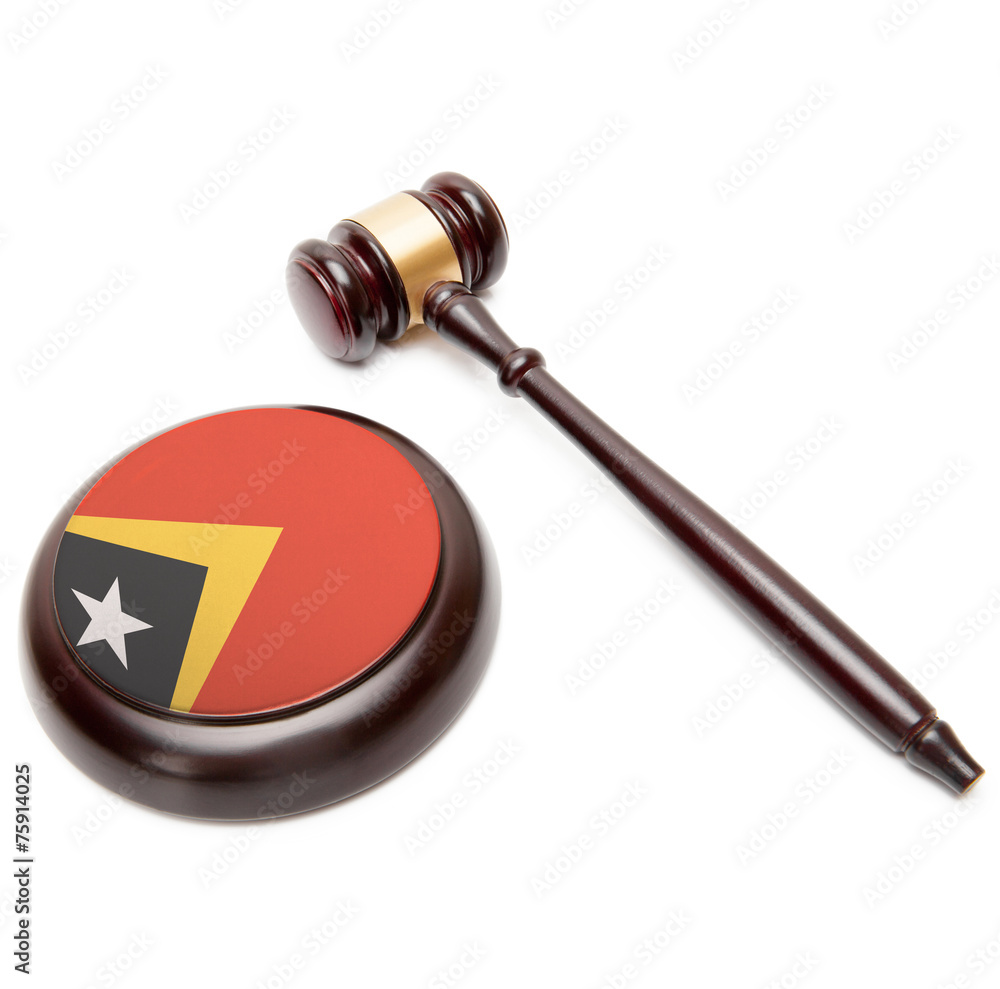 Judge gavel and soundboard with national flag on it - East Timor