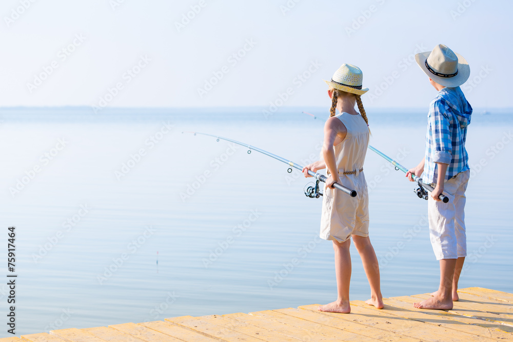 Boy and girl with fishing rods Boy and girl with fishing rods