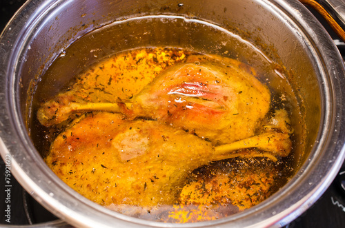 Traditional slow cooked duck confit in the pot