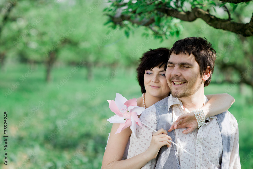 Fototapeta premium Young tenderness couple relax in blossoming garden