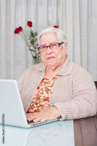 Grandmother using laptop at home