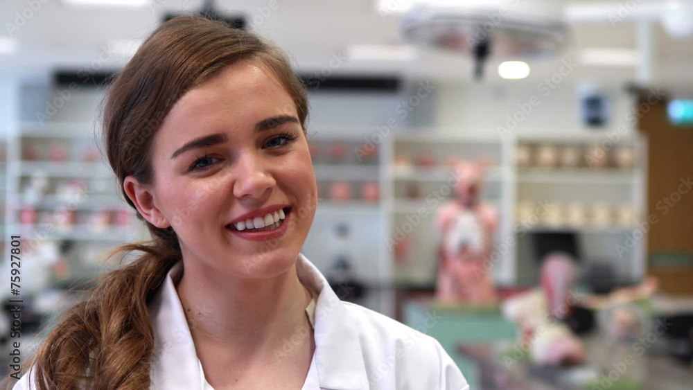 Pretty medical student smiling at camera Pretty medical student smiling at camera