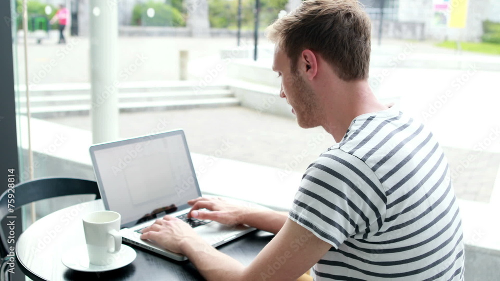 Happy student drinking coffee and typing on laptop Happy student drinking coffee and typing on laptop