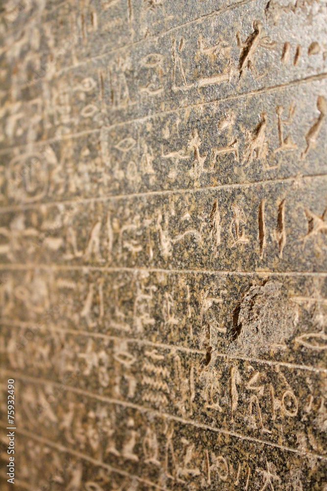 Egyptian hieroglyphics on stone relief close up