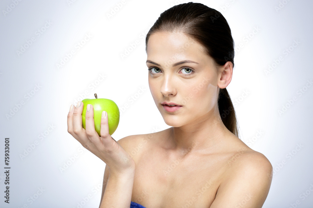 Portrait of a cute woman holding green apple Portrait of a cute woman holding green apple