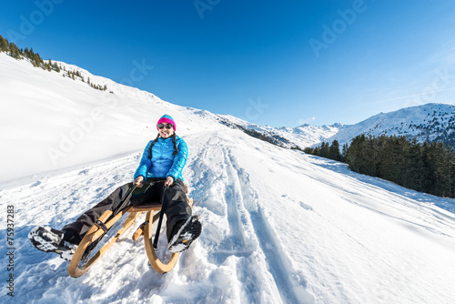Fotografie Young woman smiling on a sledge