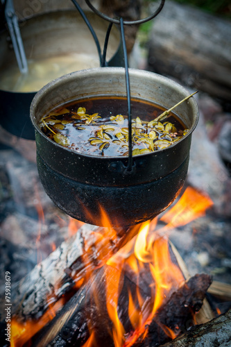 sooty pot tourist hanging over the fire