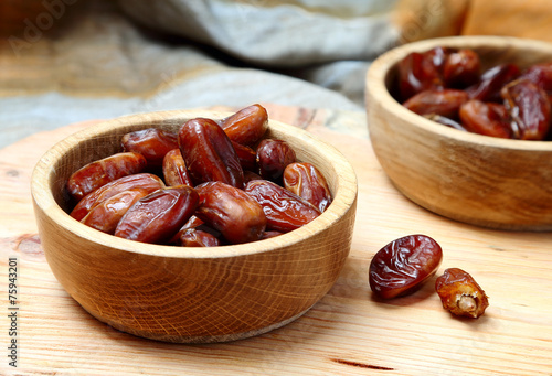 Fruits dates in wooden bowl  on  table