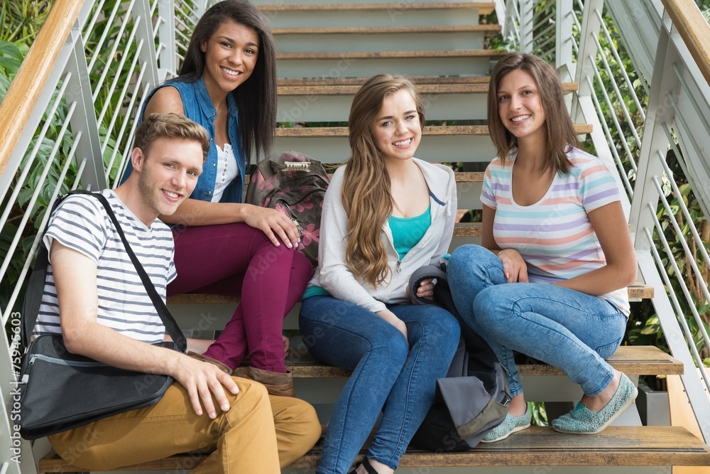Obraz premium Smiling students sitting on steps