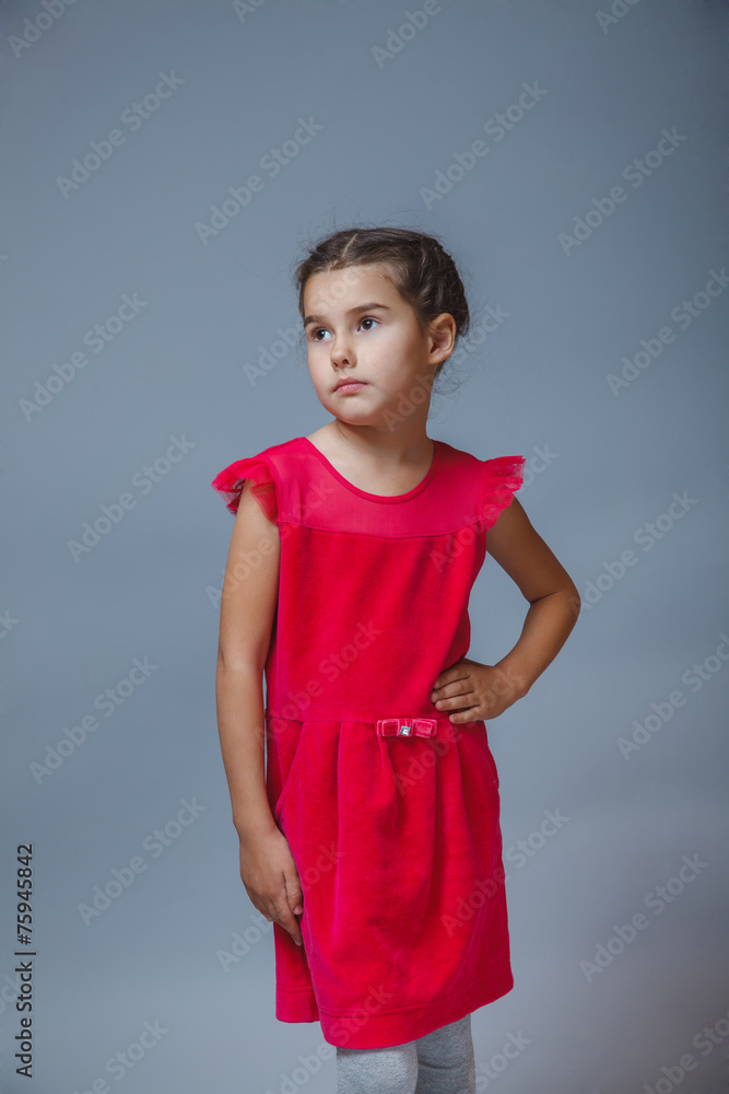 Teen girl in red dress looking thoughtfully into the distance Teen girl in red dress looking thoughtfully into the distance