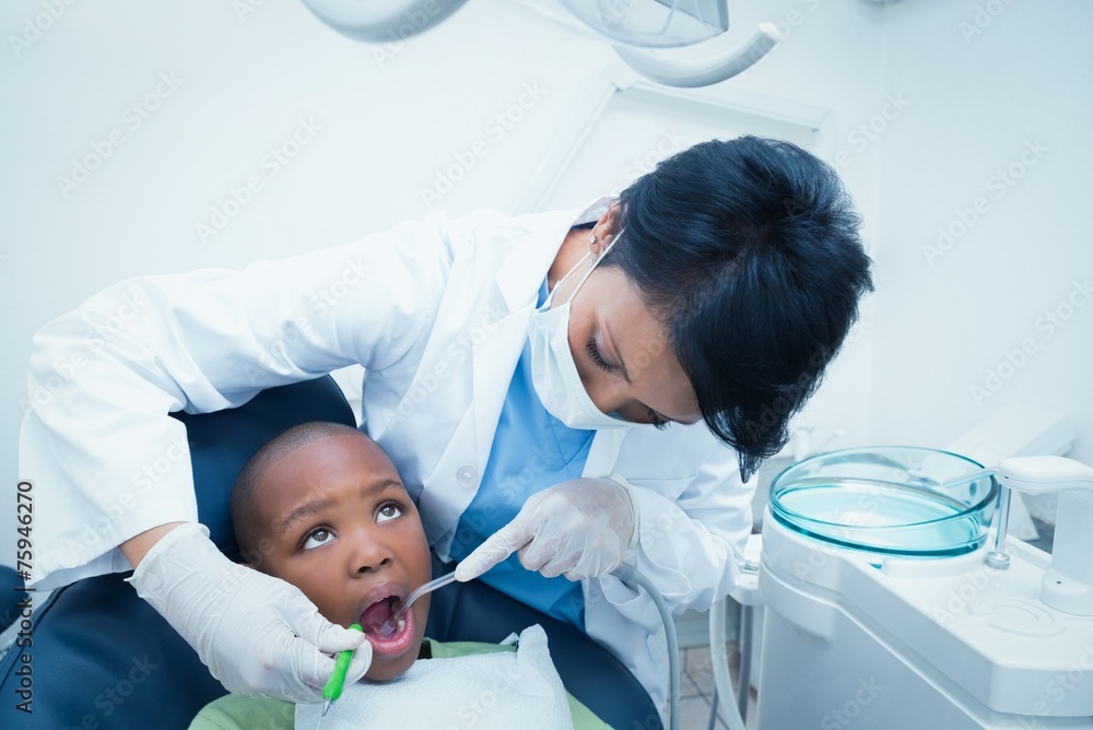 Female dentist examining boys teeth Female dentist examining boys teeth