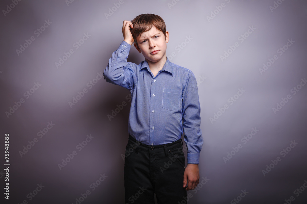 boy shirt ponders over gray background