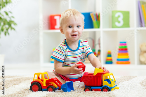 child boy playing with toy car