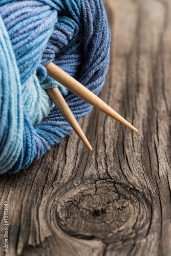 Natural woolen yarn knitting vintage wooden background