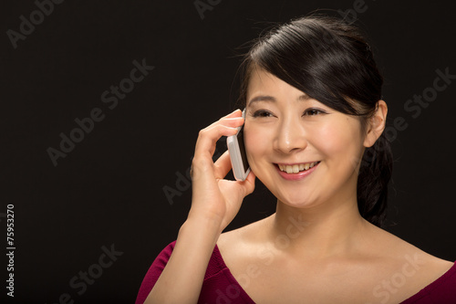 Young Asian woman talking on cellphone