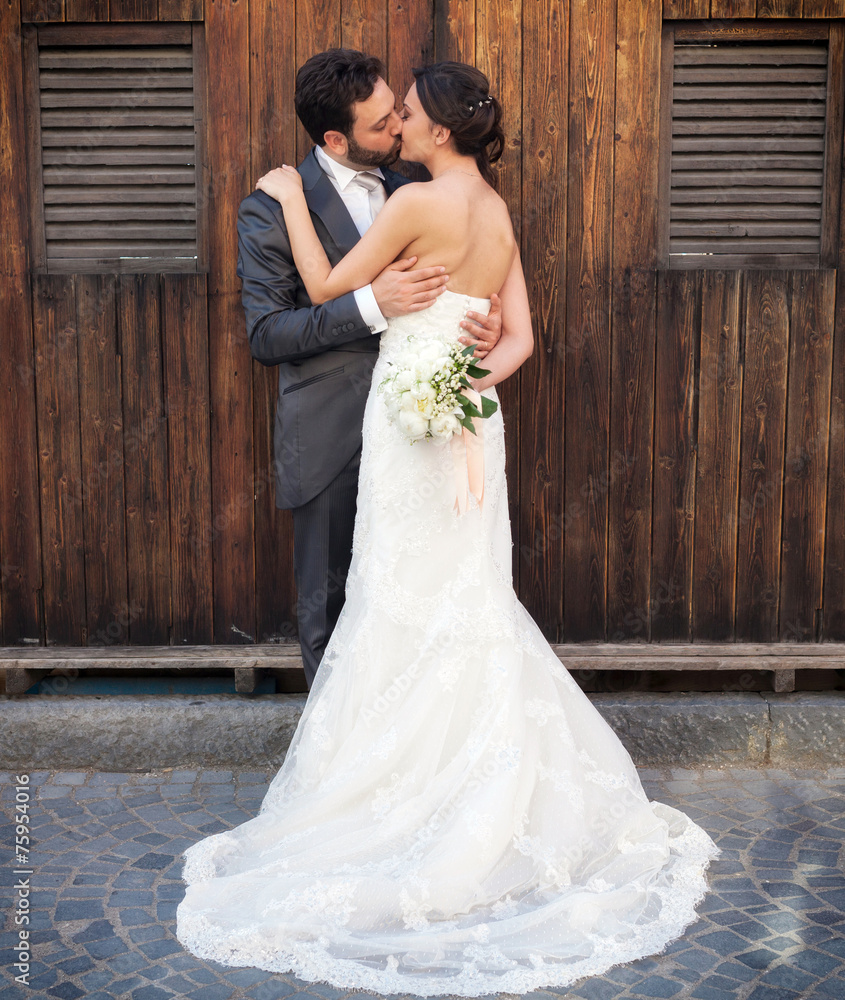 Married couple near wooden cabins Married couple near wooden cabins