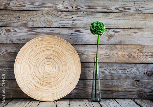 Fototapeta Naklejka Na Ścianę i Meble -  beautiful vase on a woowith a flower on backgroundden plate