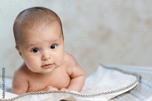 beautiful baby lying on  changing photo