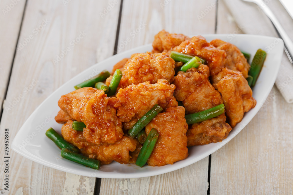 pieces of chicken in batter with spicy sauce and green beans pieces of chicken in batter with spicy sauce and green beans