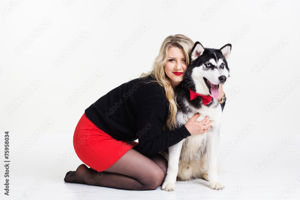 Young girl with her husky dog isolated on white