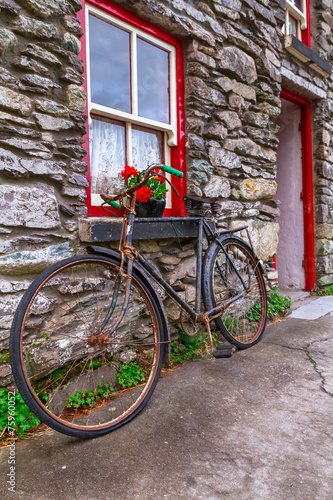 Old rusty bike at Irish cottage house #75960052