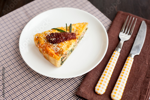 Piece of pie with spinach and fish salmon